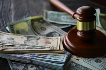 judge gavel and money on brown wooden table concept