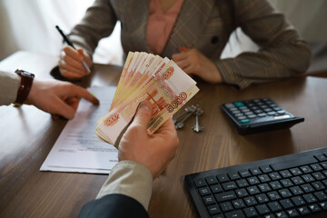 Businessman giving money, Russian Ruble currency, to hs partner - payment, loan and bribery concept