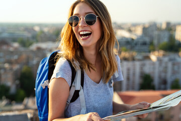 Young woman, student traveler with backpack enjoying summer vacation.