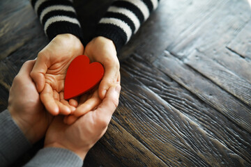 Hands of a woman holding and offering a heart shape. Love, health concept. Selective...