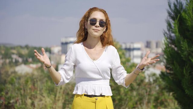 Woman making chatty expressions looking at camera.