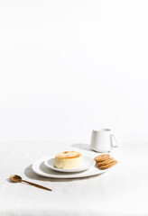 Cheesecake with Cookies and Coffee on a Minimalist Table, White Background with Text Space.