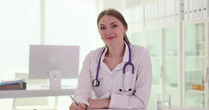 Smiling professional female doctor therapist in clinic. Medical services and insurance