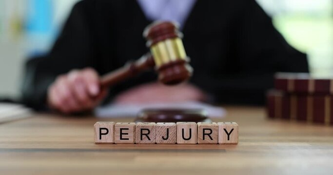Judicial gavel of justice with text of perjury of judge in courtroom. Crime of knowingly providing false information to law enforcement agencies
