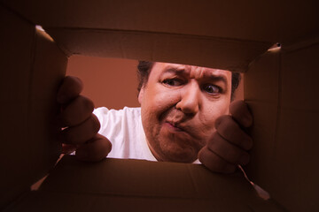 Funny fat man unpacking a gift. Stormy emotions and different situations.
