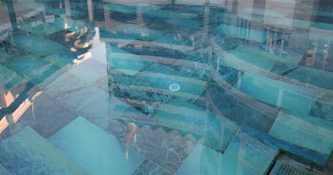 Blue tiles and swimming pool filled with water. Clean pool with water
