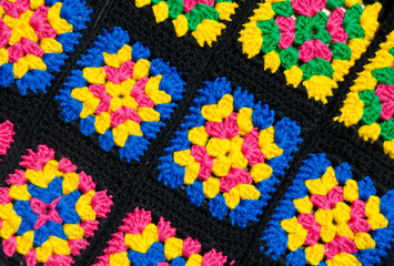 Colorful cotton granny square. Crochet texture close up photo.