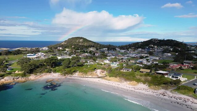Bicheno, Tasmania: Aerial drone footage of the beach at Bicheno coastline with a rainbow close to the famous Coles bay in Tasmania in Australia. 