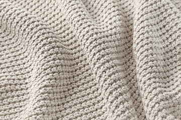 The texture of a large knitted gray sweater folded in waves. High quality background for design and layout
