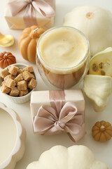 Pumpkin coffee, gift boxes and zucchini on white background