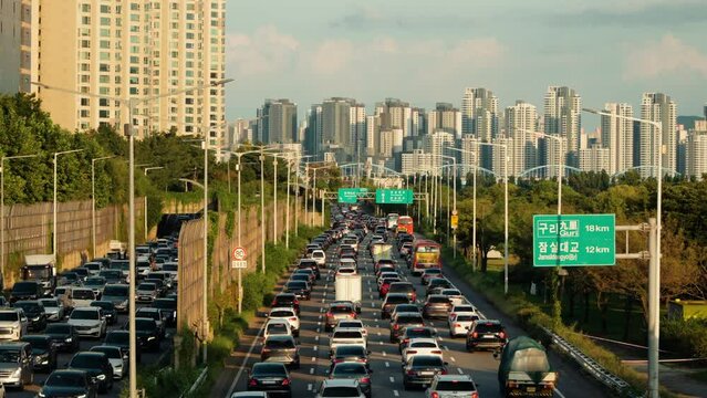 Commuters Stuck in Slow Moving Traffic After Work During Rush Hour in Seoul, South Korea. Gangbyeonbuk-ro Expressway in Summer on Sunset
