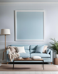Simple interior design of a modern living room with a pastel blue fabric sofa and cushions and a blank poster frame.