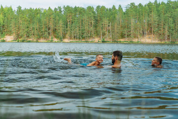 father and children swimming in forest lake. Man teaching son to swim