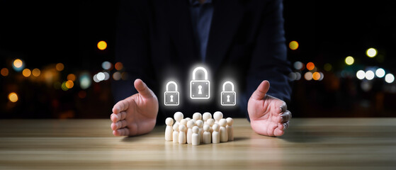 Businessman hands protect wooden dolls with security lock, planning, saving family, preventing risk...