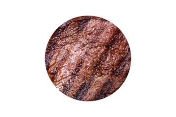 Delicious fresh juicy beef steak with spices and herbs on a dark concrete background