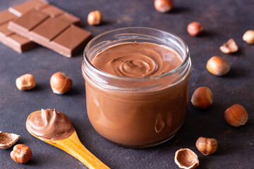 Chocolate paste with nuts in a jar. Dessert. Vegetarian food.