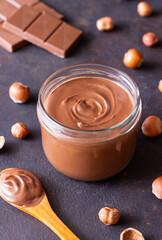 Chocolate paste with nuts in a jar. Dessert. Vegetarian food.