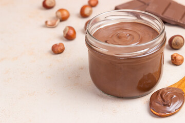 Chocolate paste with nuts in a jar. Dessert. Vegetarian food.