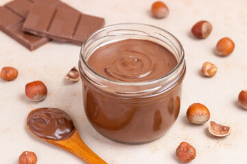 Chocolate paste with nuts in a jar. Dessert. Vegetarian food.