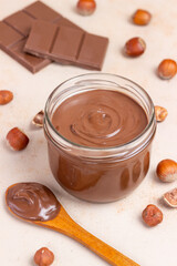 Chocolate paste with nuts in a jar. Dessert. Vegetarian food.