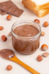 Chocolate paste with nuts in a jar. Dessert. Vegetarian food.