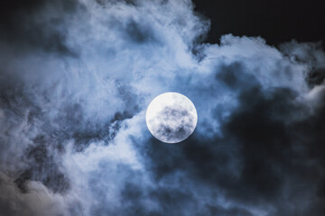 Fototapeta na wymiar Blue Moon among clouds
