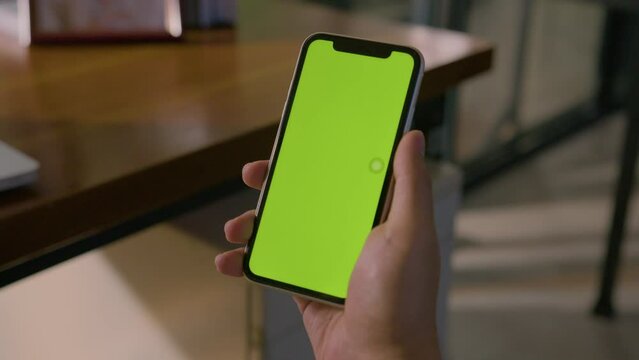 Static Mid Shot Of A Man Holding Smartphone With Chroma Green Screen In A Corporate Environment