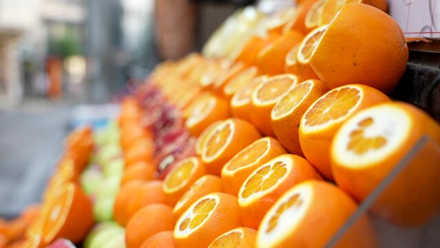 Close up of rows of fresh cut oranges on the counter of a fruit street shop. Drink natural juice in Istanbul, Turkey