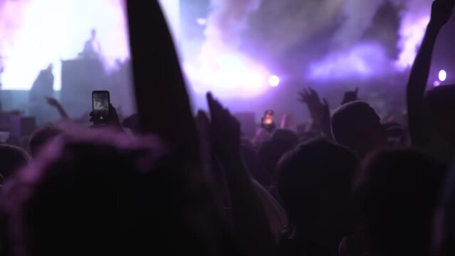 People dancing in a festival at night slow motion