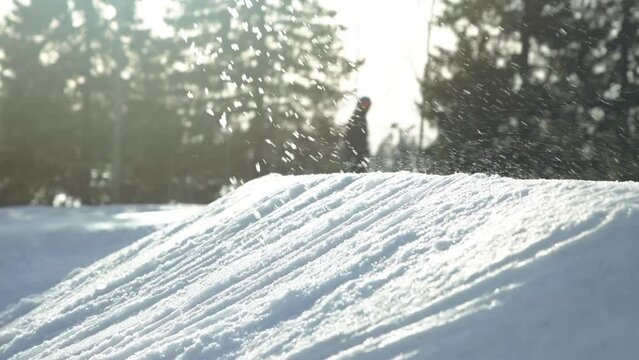 Close up of a skier jumping a jump at a ski resort slow motion