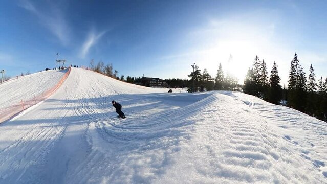 Action shot of a snowboarder jumping a jump at a ski resort