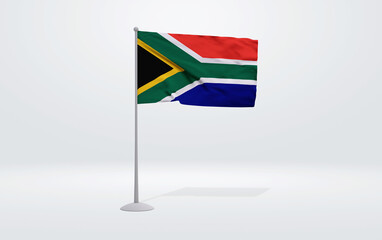 3D illustration of a South African flag extended on a flagpole and a studio backdrop in the background.