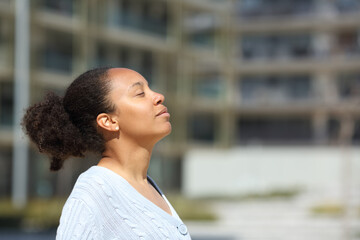 Black woman breathing fresh air in urban scene