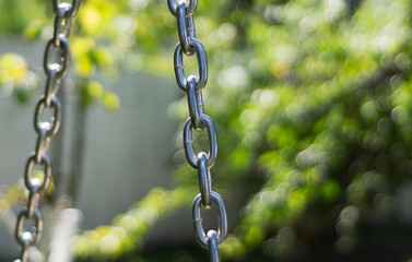 Steel chain links on a blurred background