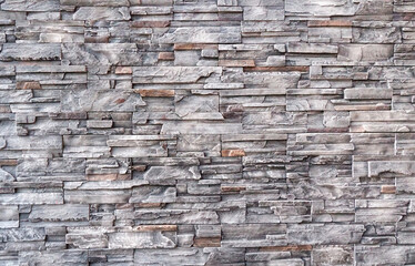 Empty brown and gray stone brick wall made with blocks for abstract  background and texture. beautiful patterns, space for work, banner, wallpaper close up, horizontal.
