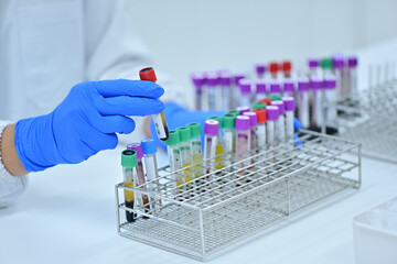 Medical technologist using diagnostic equipment in a cancer hospital lab in Asia