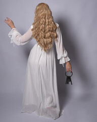 Full length portrait of blonde woman  wearing  white historical bridal gown fantasy costume dress....
