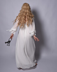 Full length portrait of blonde woman  wearing  white historical bridal gown fantasy costume dress....