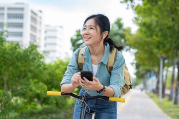 Young woman riding bike and listening music.
