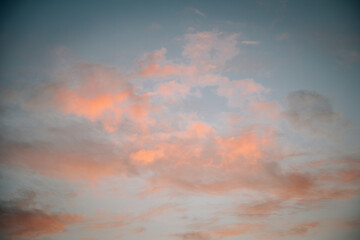 Dramatic clouds in the sky with pink, orange and red sunset lighting