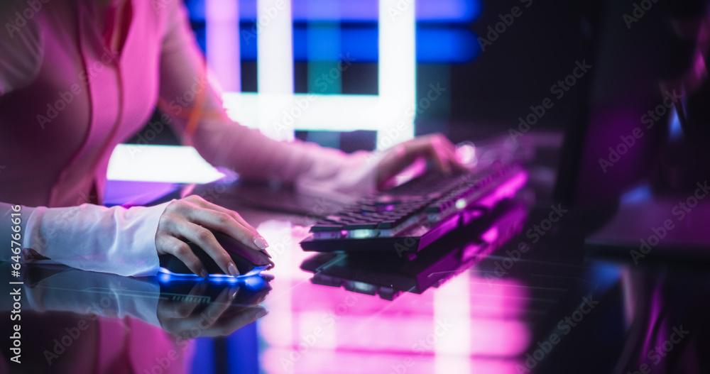Poster close up of a female gamer girl playing on a computer. focus on hands using keyboard and mouse. stre