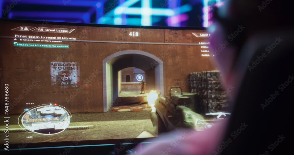 Poster close up of a female gamer girl playing first-person shooter online video game on a computer. focus 