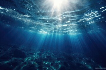 Obraz premium Sunlight streaming through clear blue water in the ocean
