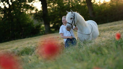 Junges Mädchen mit ihrem Pony im Kornfeld