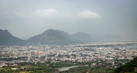 crowded city houses landscape with misty mountain background at morning from flat angle