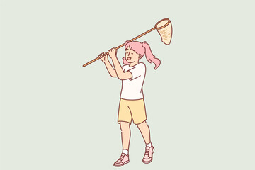 Little girl with scoop-net in hands runs after butterflies, enjoying summer vacation in nature