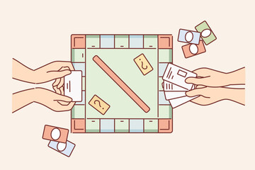 Hands of people playing monopoly and holding toy currency to make purchases in financial game