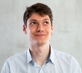 Obraz premium Emotions, people and positive concept man expresses different on gray background