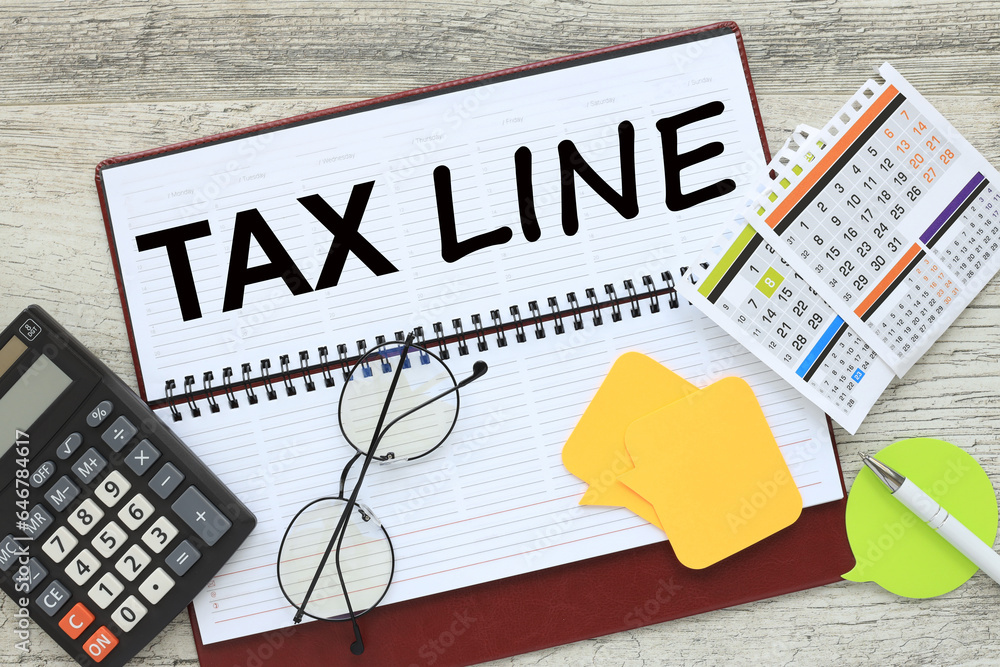Poster tax line. notepad with text near calculator and calendar