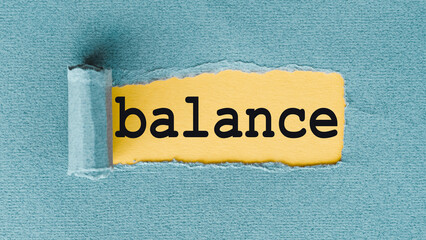 BALANCE word written on yellow under torn paper.